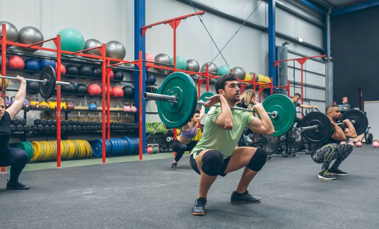 People practicing weightlifting in the gym