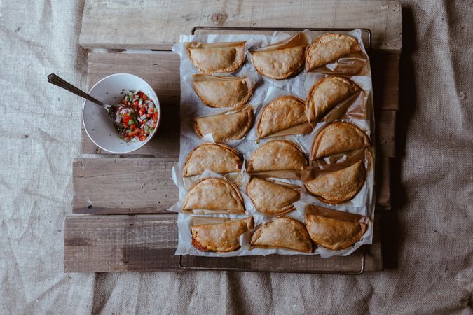 Baking tray with composed freshly baked pies patty