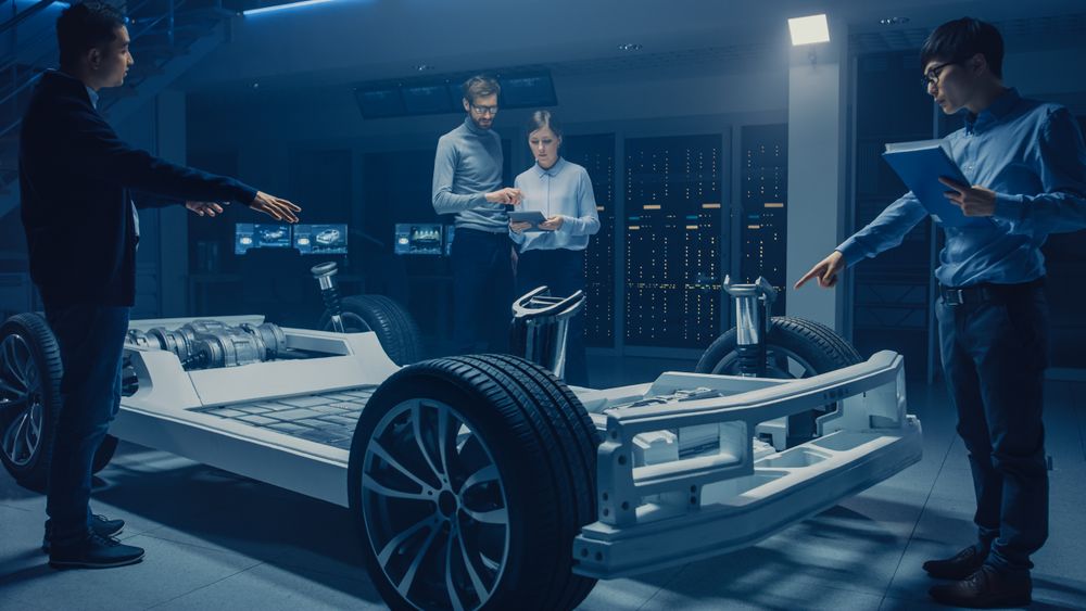 Automobile Design Engineers Working on Electric Car Platform Chassis Prototype, Using CAD Software for 3D Concept