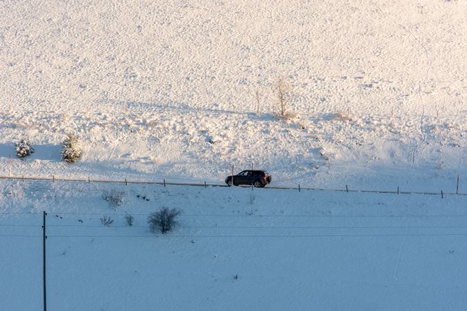 SUV car driving through snowy nature in Germany