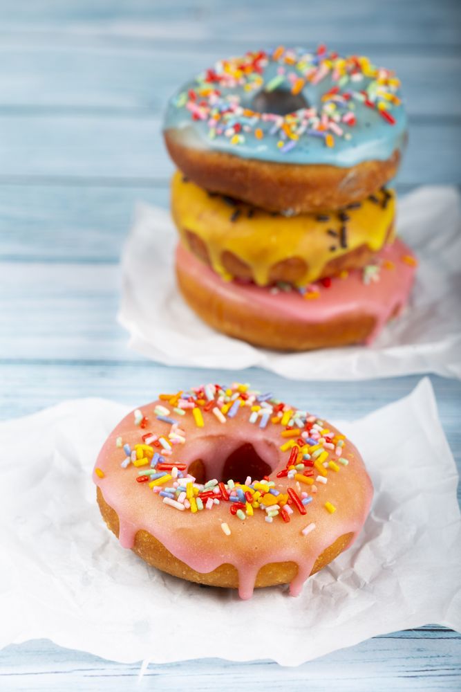 Delicious assorted colorful donuts on the table.