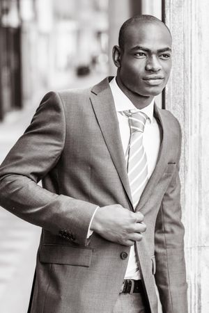 B&W picture of male closing buttons on his business suit