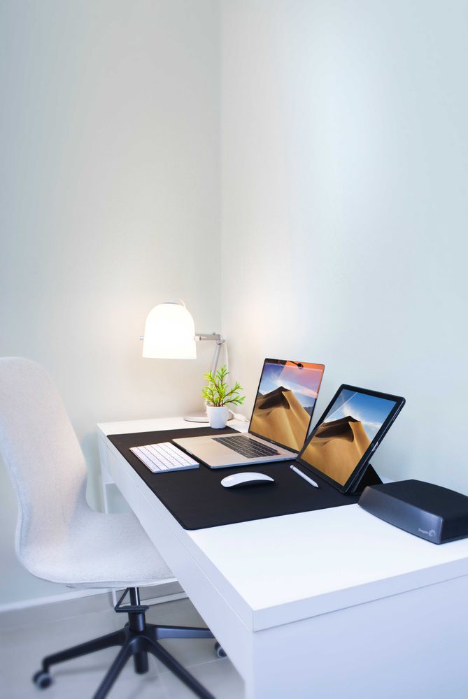 Two laptops on light desk