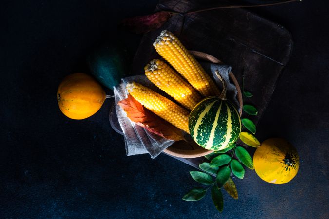 Top view of elegant cutlery with fresh squash and corn