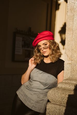 Stylish female standing near building wall