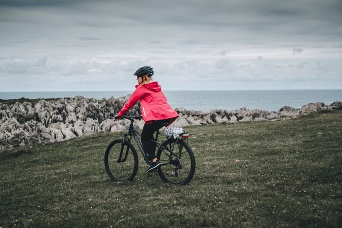 Female cyclist riding on mountain road
