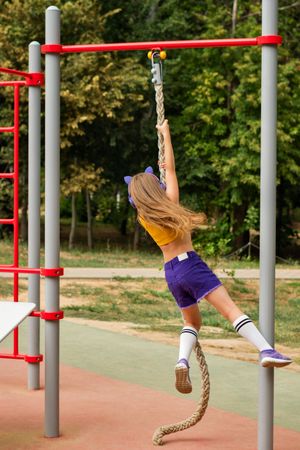 Child climbing on sports ground
