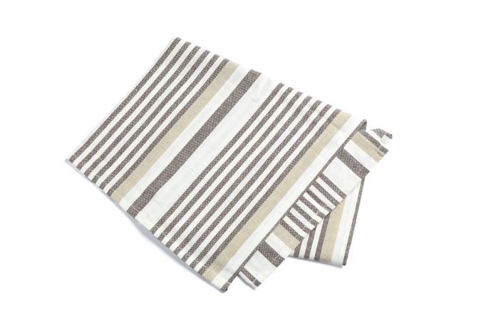 Folded fabric napkin isolated on plain background
