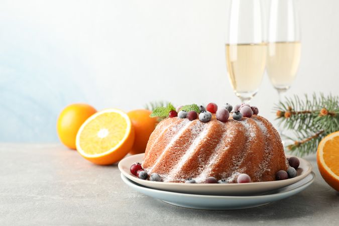 Cake with powder sugar and berries on grey table. Happy new year concept