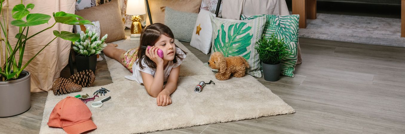 Banner of happy child talking with walkie-talkie in cozy tent. Vacation camping at home concept.