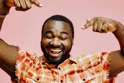 Black man smiling and dancing in studio shot