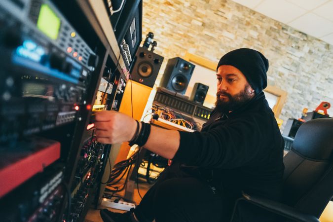 Man adjusting sound control in a studio