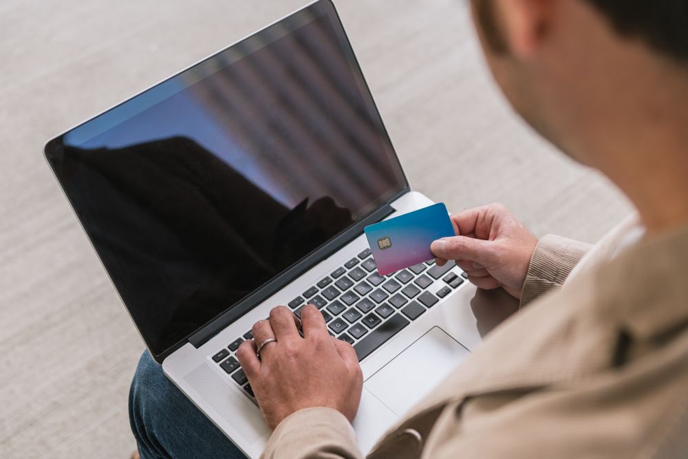Crop businessman shopping online on street