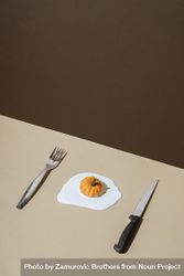 Egg with pumpkins as yoke with knife and fork 41a684