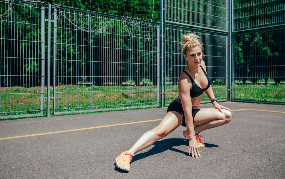 Sportswoman doing leg stretches