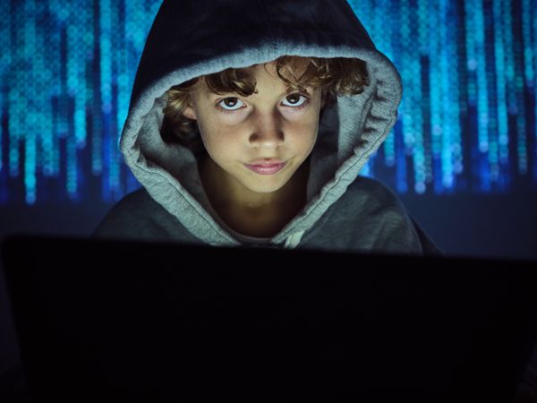 Boy in dark light on binary code background
