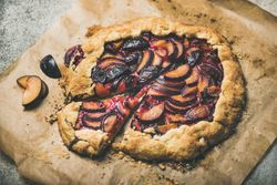 Whole fruit tart on parchment paper, close up