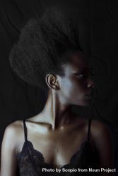 Portrait of Black woman wearing eyeliner against dark background 5nKwD4