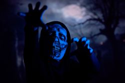 Scary zombie under blue neon light