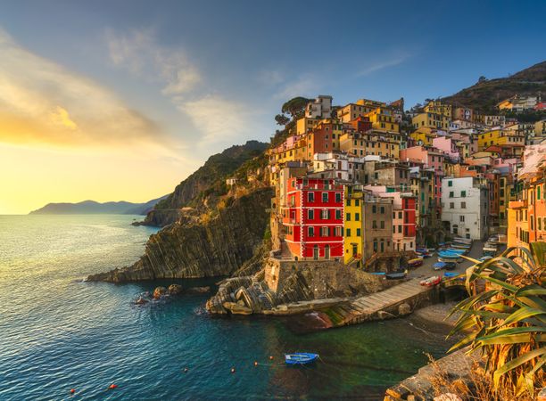 Riomaggiore town, cape and sea landscape at sunset, Cinque Terre, Liguria, Italy