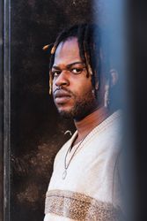 Stylish Black man with dreadlocks in buns