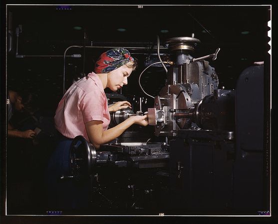Long Beach, CA, USA - 1942: Female mechanic wearing a bandana working in aviation