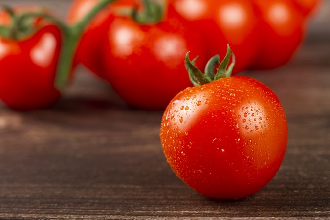 Ripe tomatoes on the wooden table.