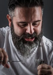 Expressive barber cutting beard