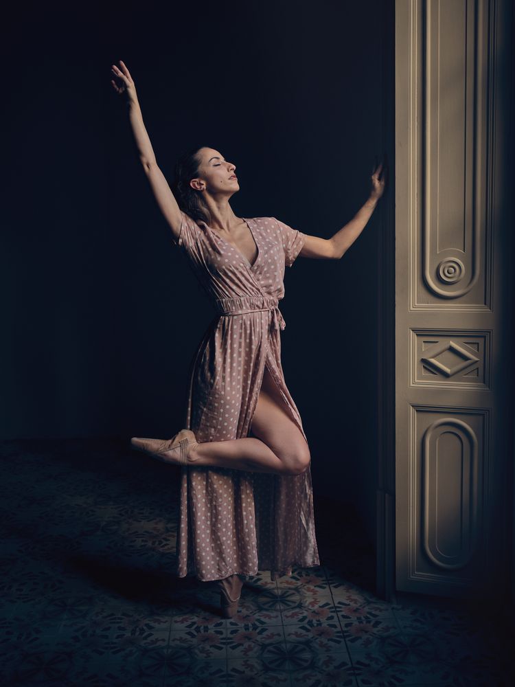 Female in pointe dancing in dark room