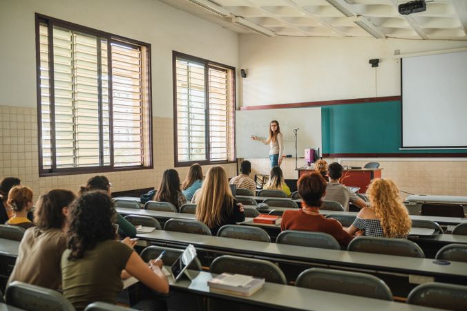 Lecturer talking to students during lesson