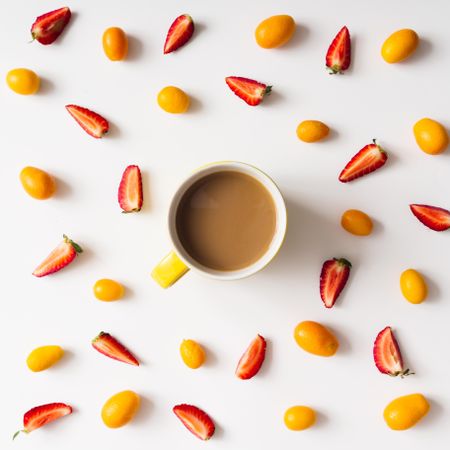 Pattern made of kumquats, strawberries with coffee cup