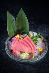 Ceramic plate with raw fish and vegetables
