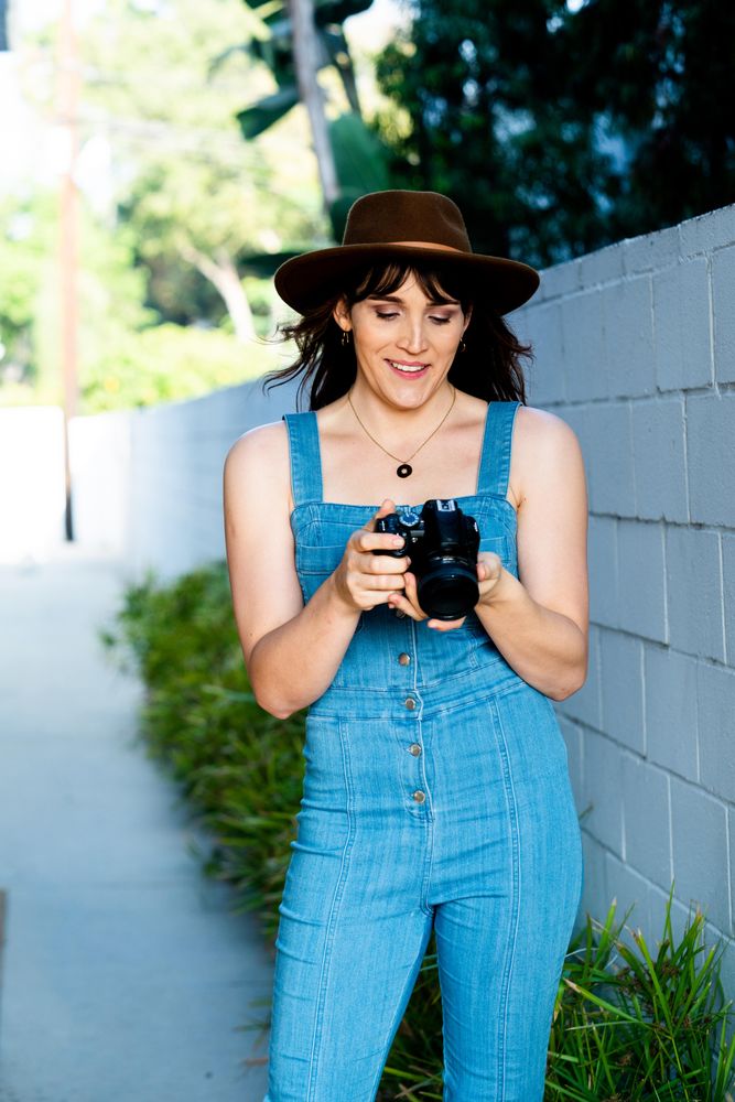 Transgender woman reviewing photos on a digital SLR