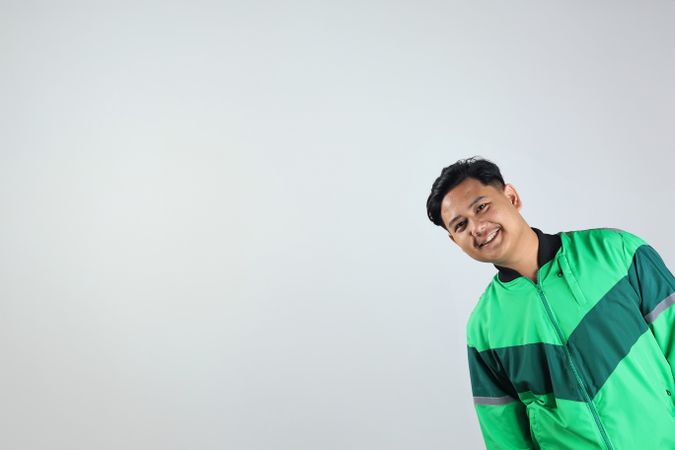 Asian Gojek Grab Online Driver with Uniform Jacket
