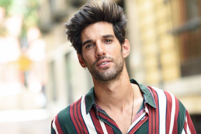 Portrait of handsome man with dark hair outside