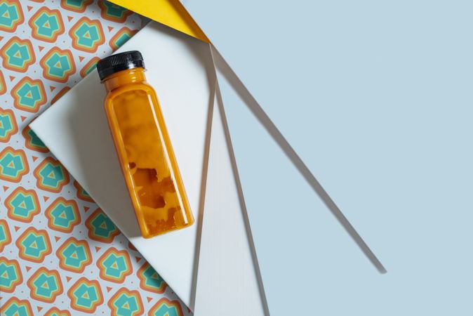 Mango and pumpkin smoothie bottle over retro textures