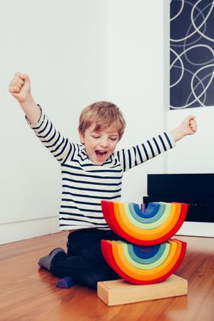 Boy playing with wooden construction pieces