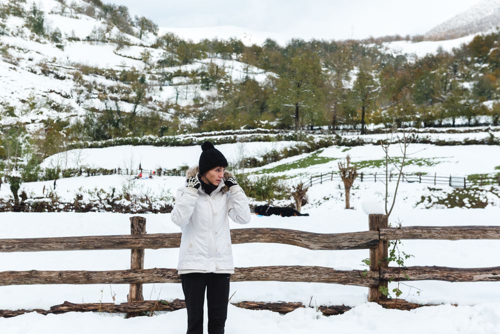 Woman in winter clothes looking away