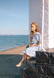 Girl by the sea with white pillar