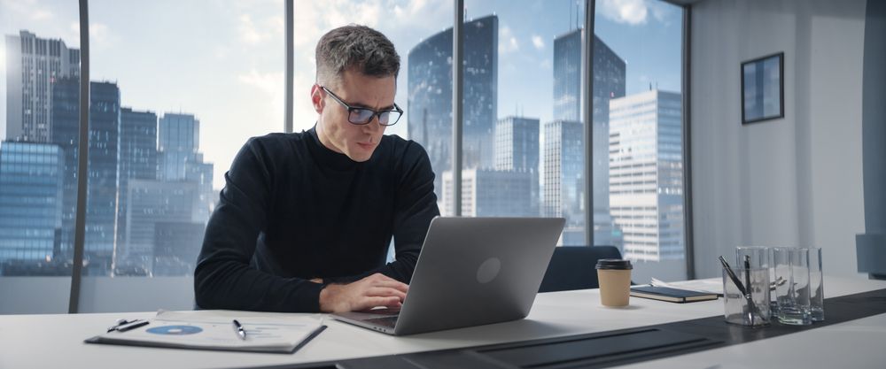 Businessman Standing In Corner Office And Thinking Infront Big Window With Megapolis Cityview.