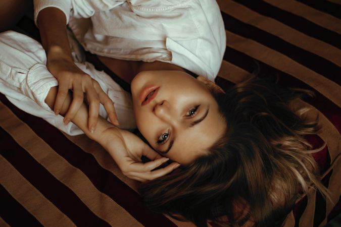 Woman lying on textile