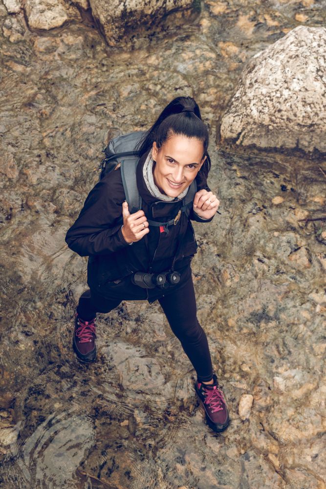 female traveler smiling at camera during hiking trip