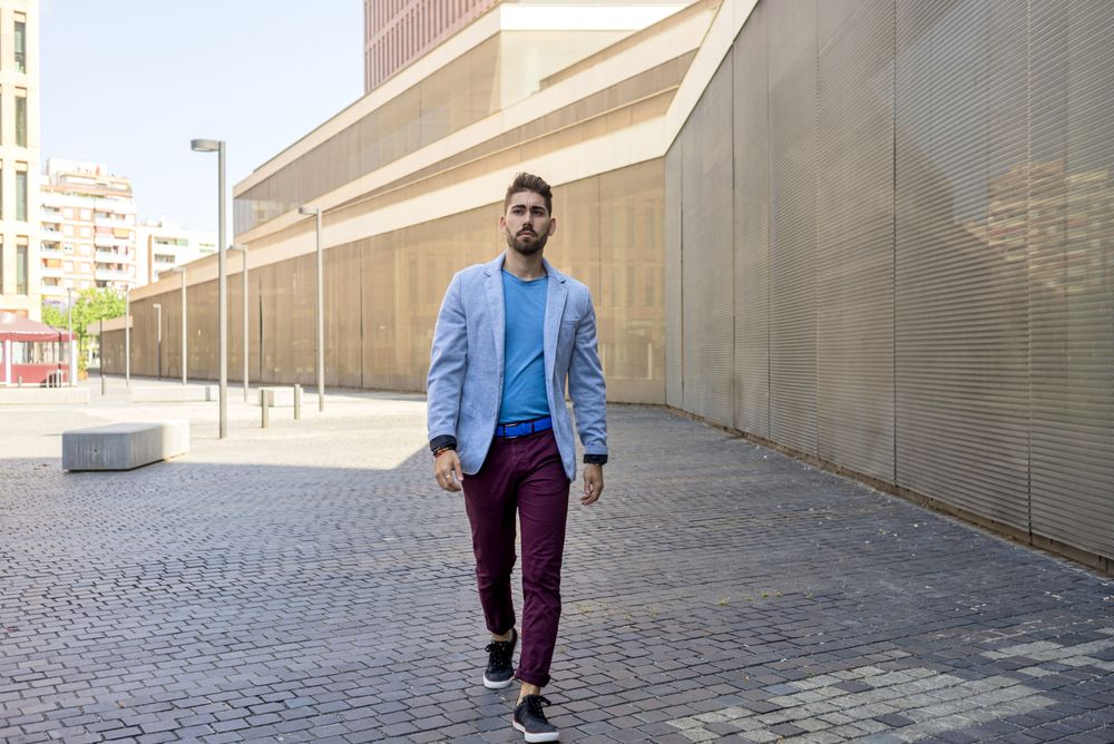 Man in blazer walking on street