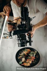 Cropped image of photographer taking photo of sushi plate 0WLGW5