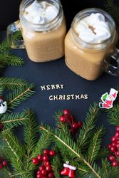 marshmellou hot cocoa trees in the background. The inscription Merry Christmas