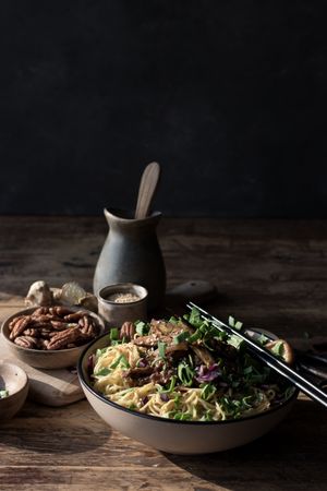 Miso noodles with egg plants and shiitake in bowl on table