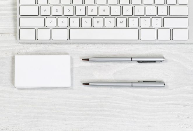 Blank business cards and pens on plain desktop