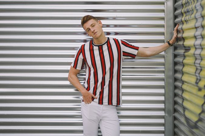 Man leaning on steel garage door