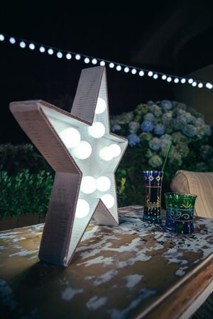 Star lamp with light bulbs over table