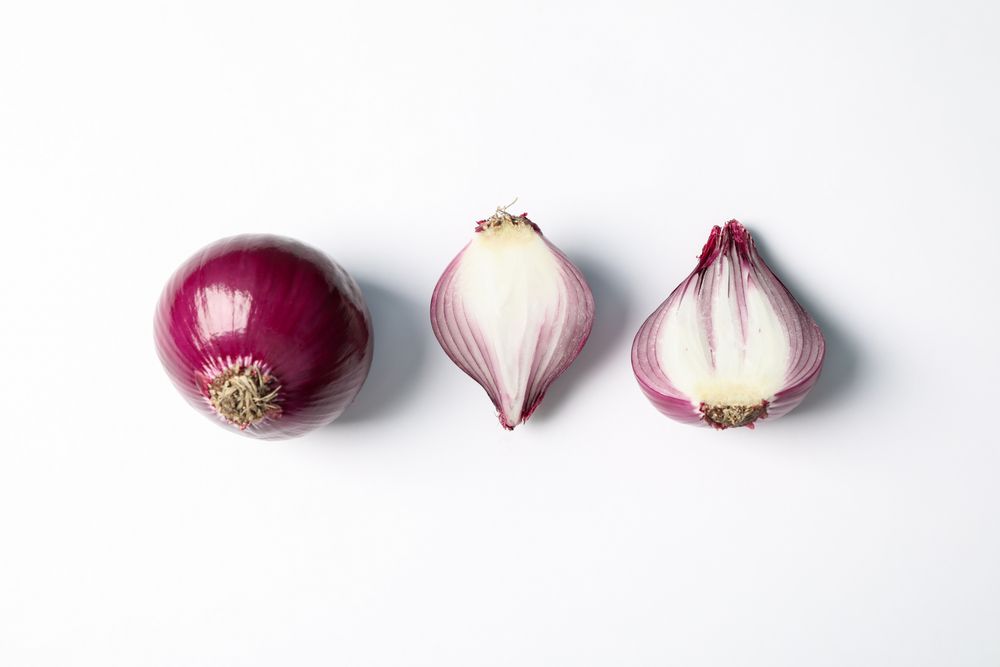 Flat lay composition with red onion on plain background